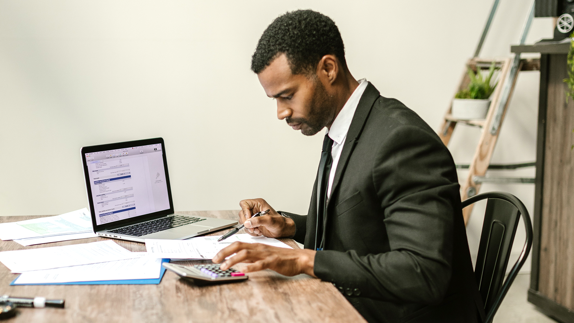 Image of a man looking at a computer as though he is doing taxes